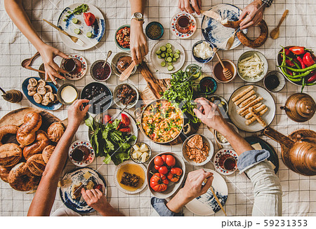 Flat-lay family sitting and having traditional Flat-lay family sitting and having traditional 59231353