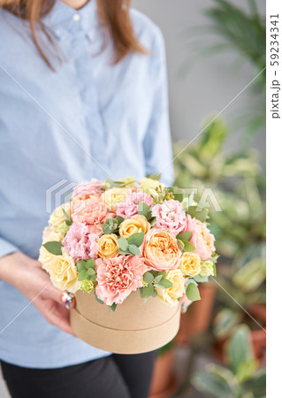 Beautiful spring bouquet in round box. Arrangement with various flowers. The concept of a flower 59234341