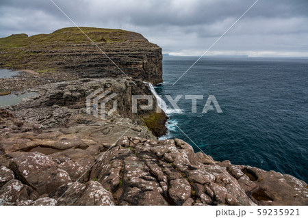 Bosdalafossur waterfall to the ocean on Faroe Islands coastline 59235921