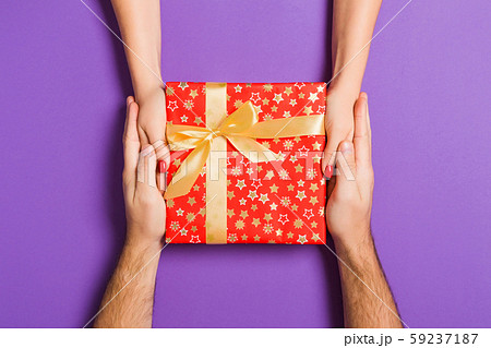 Top view of holding a gift in female and male 59237187