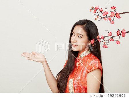 Woman in traditional chinese red dress with plum Woman in traditional chinese red dress with plum 59241991