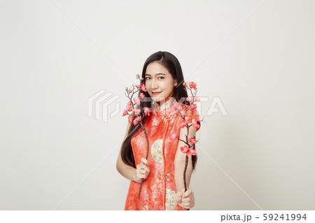 Woman in traditional chinese red dress with plum 59241994