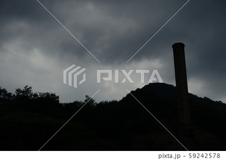 暗雲と山と煙突　シルエット　不穏で陰鬱なイメージ 59242578