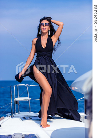 Young happy woman in black dress enjoying evening 59245283