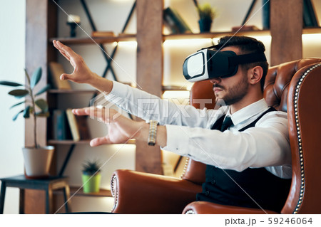 Man wearing virtual reality goggles Man wearing virtual reality goggles 59246064