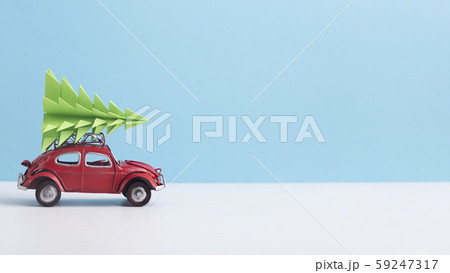 Red toy car with pine tree on the top on background Red toy car with pine tree on the top on background 59247317