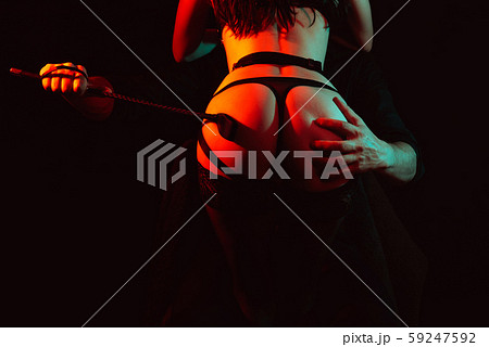 dominant man passionately slaps the whip on the big ass of the submissive girl dominant man passionately slaps the whip on the big ass of the submissive girl 59247592