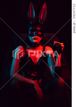 sexy dominatrix woman in erotic lingerie with Bunny mask with leather handcuffs 59247712