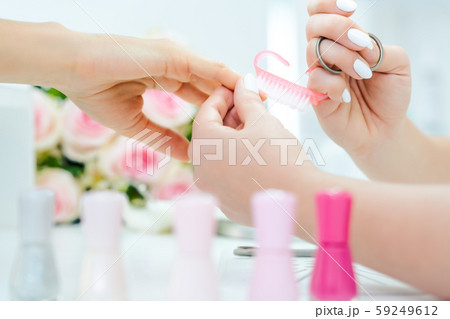 Nails of woman being prepared for manicure Nails of woman being prepared for manicure 59249612