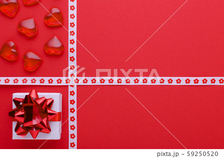 red background with gift box and hearts, copy space 59250520