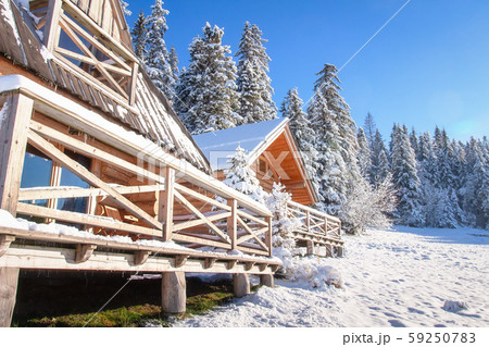 Winter scene with wooden house in snowy forest on Winter scene with wooden house in snowy forest on 59250783