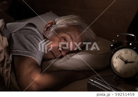 Depressed senior man lying in bed cannot sleep from insomnia 59251459