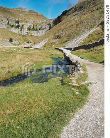 Track leading to cleft of Gordale Scar with Gordale Beck flowing alongside, Malham, Yorkshire Dales Track leading to cleft of Gordale Scar with Gordale Beck flowing alongside, Malham, Yorkshire Dales 59251479