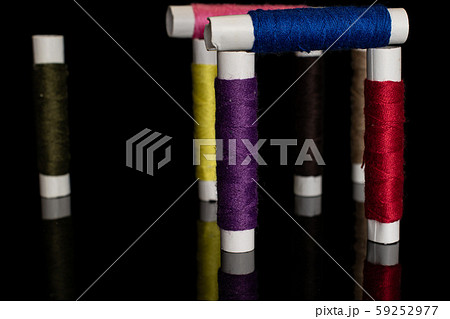 Sewing thread spool isolated on black glass Sewing thread spool isolated on black glass 59252977