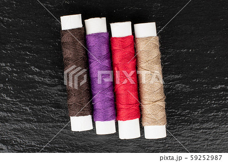 Sewing thread spool on grey stone Sewing thread spool on grey stone 59252987