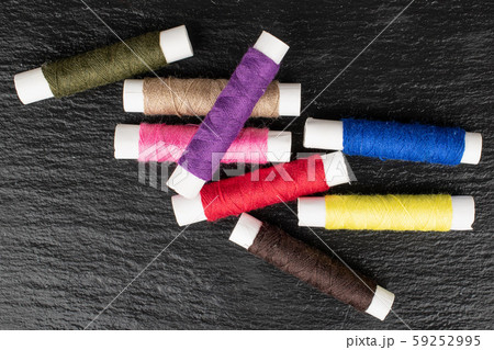 Sewing thread spool on grey stone Sewing thread spool on grey stone 59252995