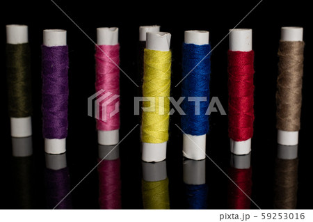 Sewing thread spool isolated on black glass 59253016