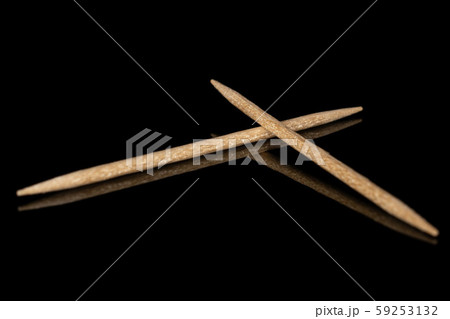 Wooden brown toothpick isolated on black glass Wooden brown toothpick isolated on black glass 59253132