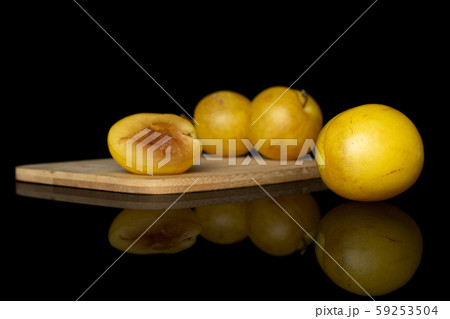Fresh yellow plum isolated on black glass Fresh yellow plum isolated on black glass 59253504