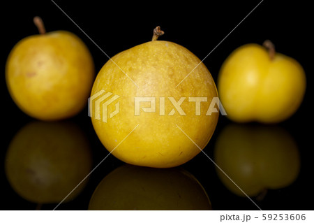 Fresh yellow plum isolated on black glass Fresh yellow plum isolated on black glass 59253606