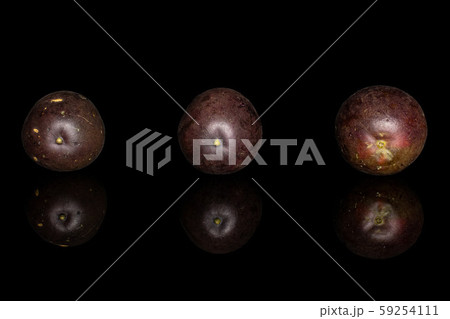 Sweet dark passion fruit isolated on black glass 59254111