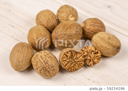 Dry brown nutmeg on grey wood Dry brown nutmeg on grey wood 59254296