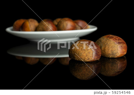 Sweet brown chestnut isolated on black glass Sweet brown chestnut isolated on black glass 59254546