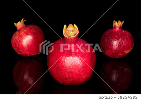 Fresh red pomergranate isolated on black glass Fresh red pomergranate isolated on black glass 59254585