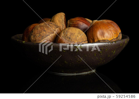 Sweet brown chestnut isolated on black glass Sweet brown chestnut isolated on black glass 59254586