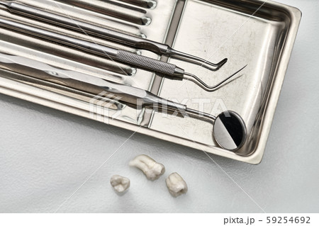 Dental instruments lying in chrome medical tray Dental instruments lying in chrome medical tray 59254692
