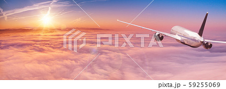 Commercial airplane flying above dramatic clouds. 59255069