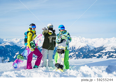 Photo of three cheerful athletes at ski resort 59255244