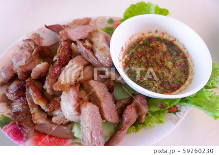 roasted pork slice white plate and chilli sauce 59260230