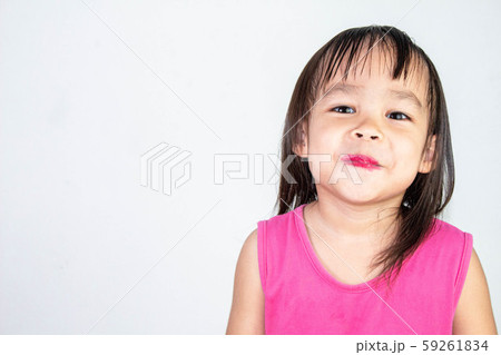 Happy Asian child girl with apply red lipstick Happy Asian child girl with apply red lipstick 59261834