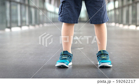 Closeup of a healthy kid's legs in running shoes standing firmly on the walkway in the school, showing the feeling of Self-confidence, Independence and Pride. Sport day, Child development, EQ, Smart. 59262217