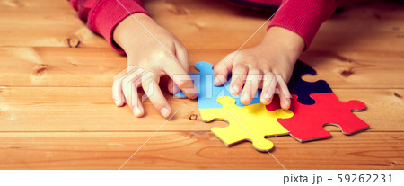 Banner picture of an autistic child's hands playing a puzzle symbol of Public awareness for autism spectrum disorder. World Autism Awareness day April 2, Supportive, Understanding and Acceptance. 59262231