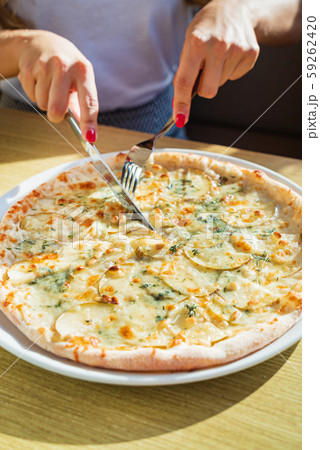 woman eating pizza in the cafe woman eating pizza in the cafe 59262420