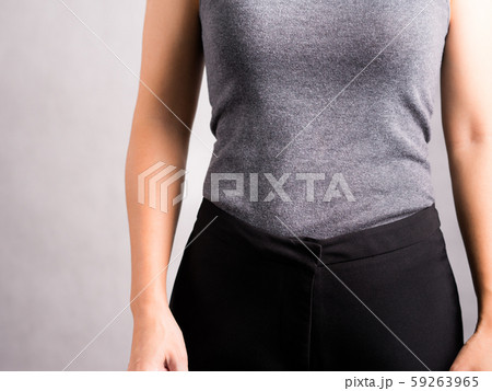 Studio closeup of a healthy, flat stomach and firm waist - woman body. Wellbeing, Abdominal muscle, Weight loss, Exercise training, Keto, Digestion, Woman health and diet concept. 59263965