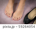 Closeup : Bare feet of woman, she take off her shoes to release pain after long day wearing pointy and narrow shoes  -  Medical condition called bunions (Hallux valgus) Woman's health concept. 59264054