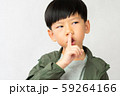 An adorable little boy touch his forefinger to his lip and do the shh.. expression. Keep quoted, Mute, Secret, Silent, Child development, No sound Concept 59264166