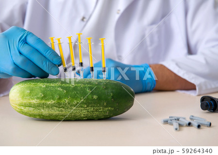 Male nutrition expert testing vegetables in lab Male nutrition expert testing vegetables in lab 59264340