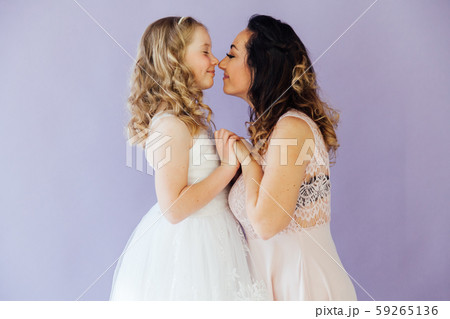 Portrait of a beautiful fashionable mom and daughter's family love 59265136