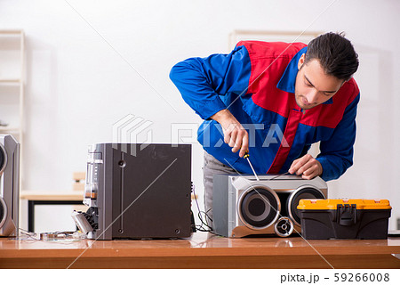 Young engineer repairing musical hi-fi system Young engineer repairing musical hi-fi system 59266008
