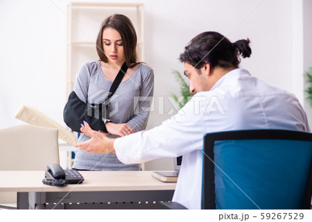 Young male doctor and female beautiful patient Young male doctor and female beautiful patient 59267529