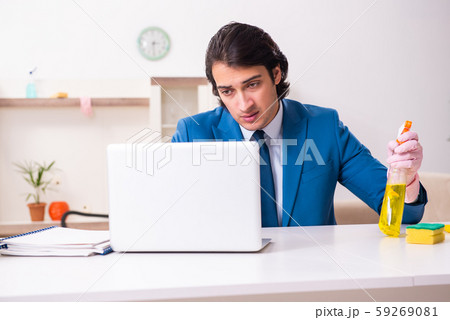 Young businessman cleaning the house 59269081