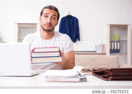 Young male student preparing for exams at home Young male student preparing for exams at home 59270252