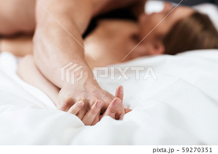 Focused on hands of passion couple having sex. 59270351