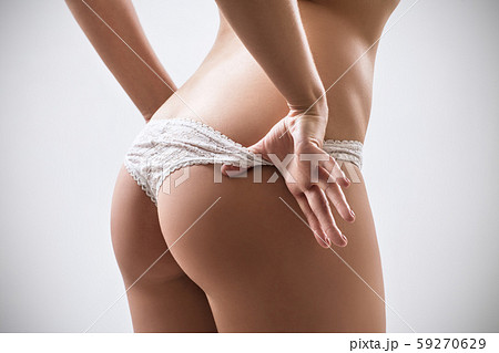 Sexy woman taking off panties on beach - Stock Photo [68271303] - PIXTA