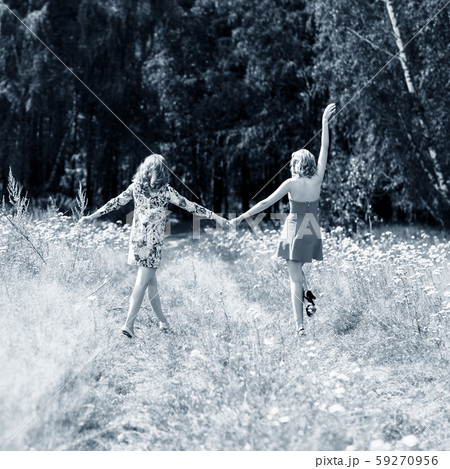 Beautiful women walking in the summer park. 59270956