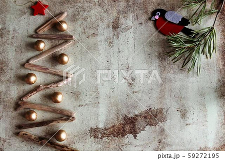 Christmas tree made of wooden branches and bullfinch on a pine branch 59272195